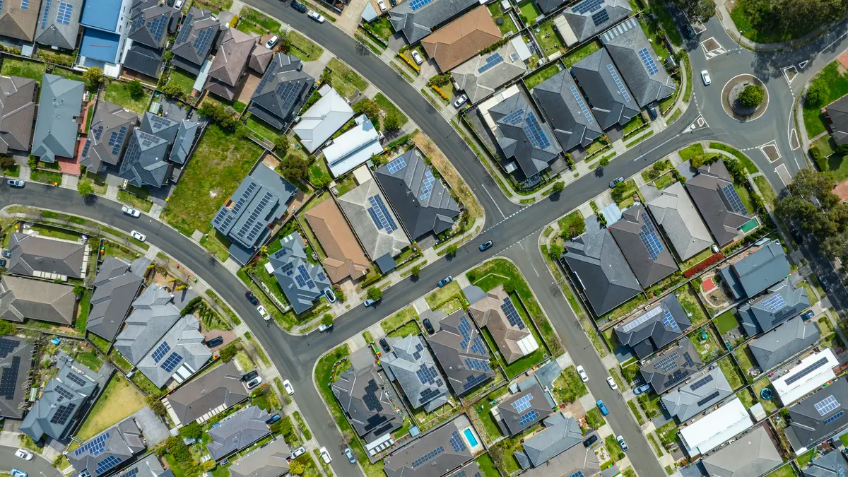An aerial view of houses and curving streets in an Australian suburb