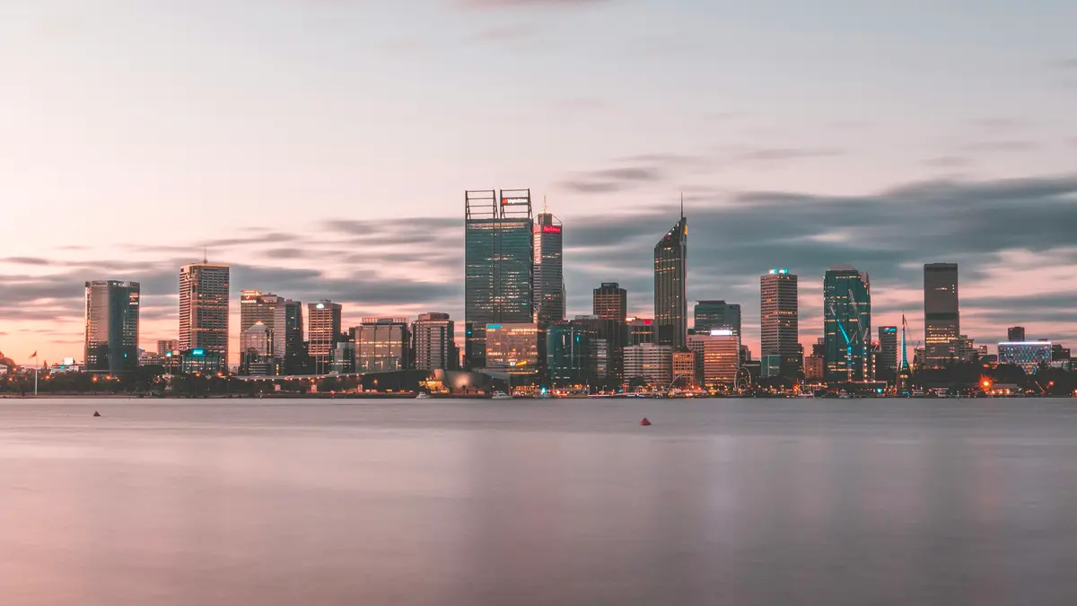 Perth's city skyline across the Swan River at dusk